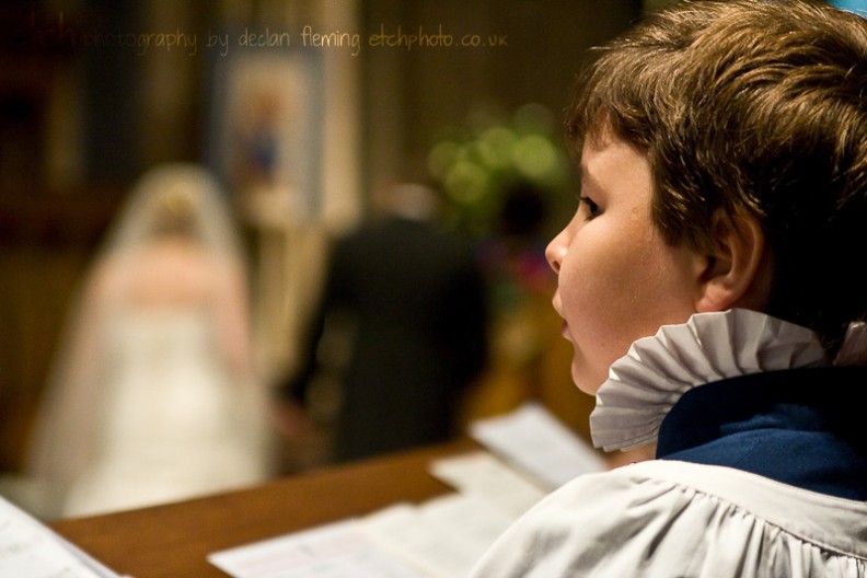 Romsey abbey wedding - choir sings as bride and groom walk down the aisle