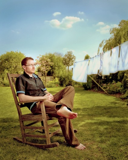 environmental portrait of a man in a chair in the garden